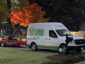 Matthew's Plumbing Van And Digger in front of fall foliage