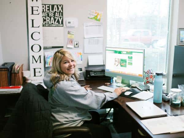 smiling office worker in Matthew's Plumbing office