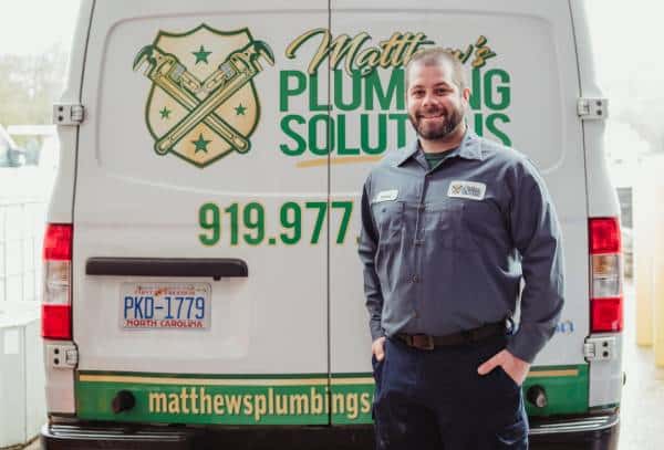 Master Plumber Matthew Wells in front of his plumbing van